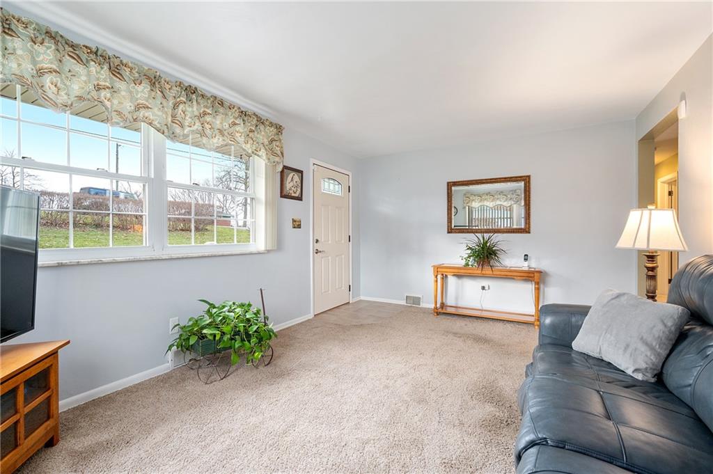 125 Lovi Road Baden, PA 15005 - Photo 11 of 25 a living room with furniture and a window