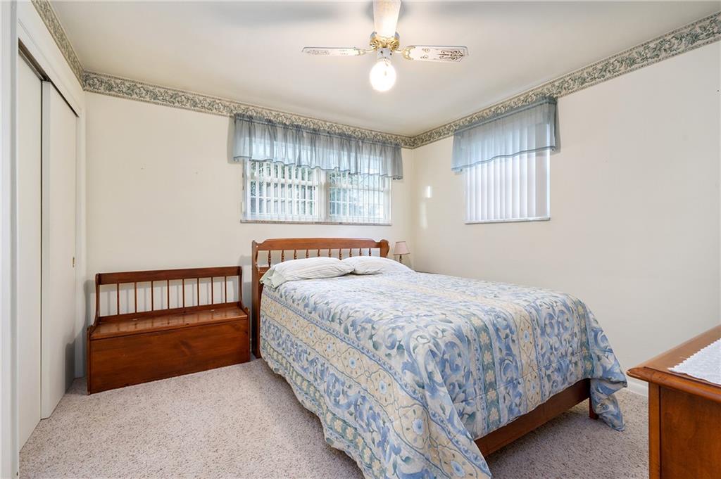 125 Lovi Road Baden, PA 15005 - Photo 13 of 25 a bedroom with a bed and a chandelier
