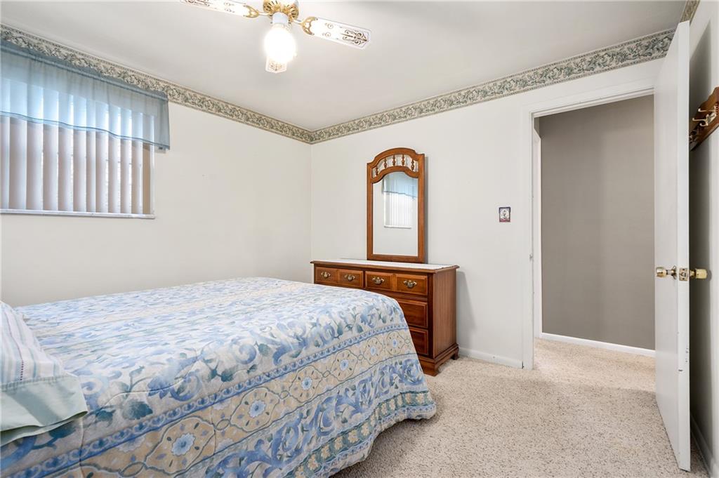 125 Lovi Road Baden, PA 15005 - Photo 14 of 25 a bedroom with a bed and a chandelier