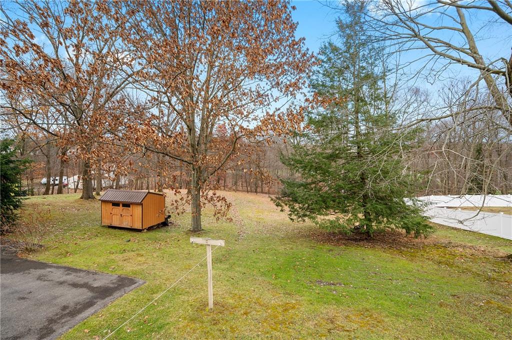 125 Lovi Road Baden, PA 15005 - Photo 7 of 25 a yellow bench sitting in the middle of a yard