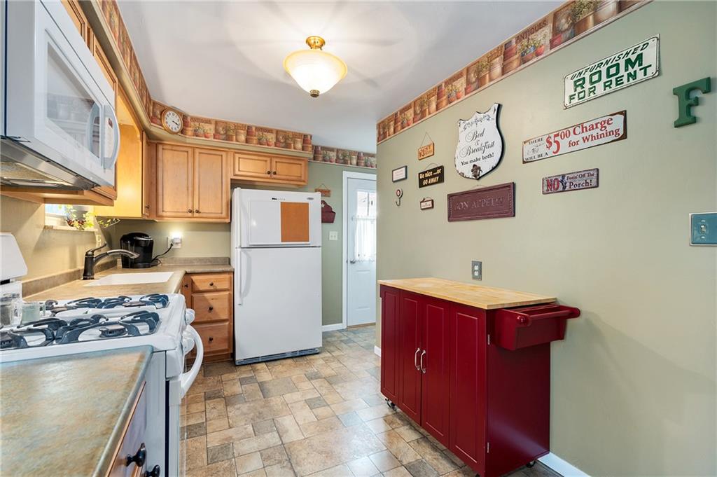 125 Lovi Road Baden, PA 15005 - Photo 9 of 25 a kitchen with stainless steel appliances granite countertop a refrigerator and a stove