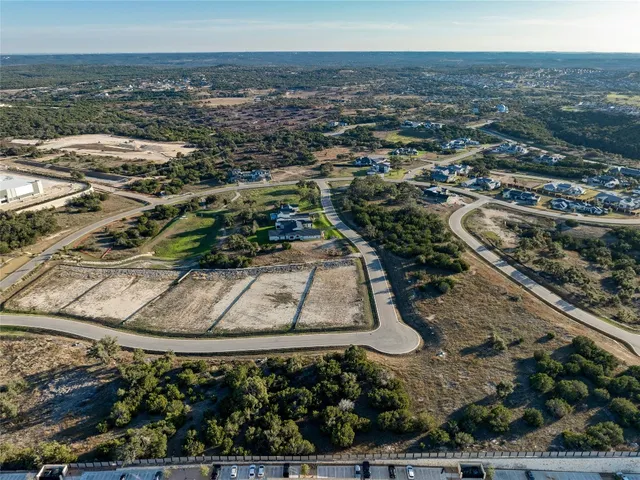 an aerial view of a residential houses with outdoor space