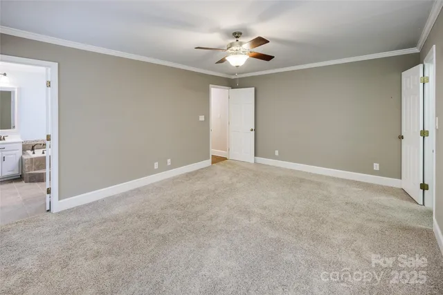 a view of an empty room with a ceiling fan