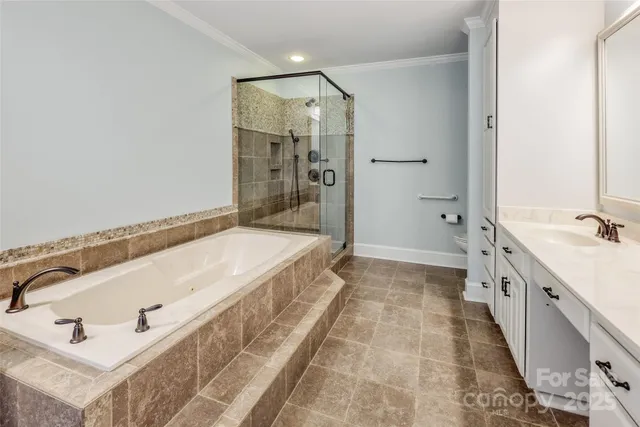a spacious bathroom with a tub sink and mirror