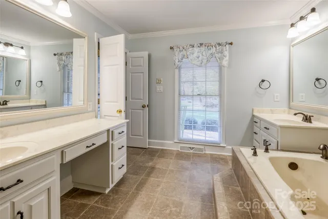 a bathroom with a tub sink and mirror