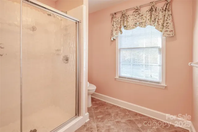 a bathroom with a shower and a toilet