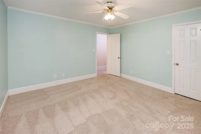 a view of an empty room with a fan