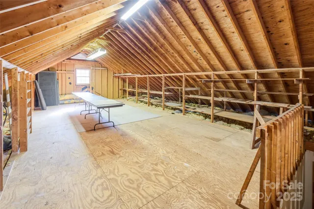 a view of a patio with table and chairs with wooden floor and fence