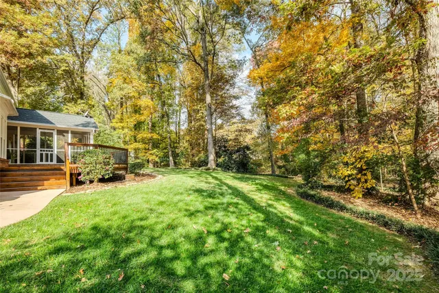 a view of a yard with plants and brick wall