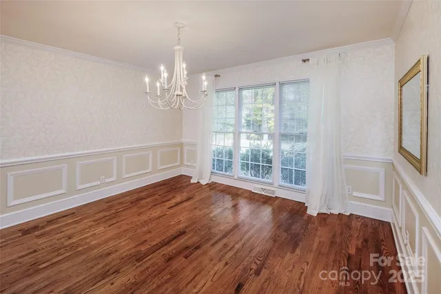 a view of wooden floor and windows in a room