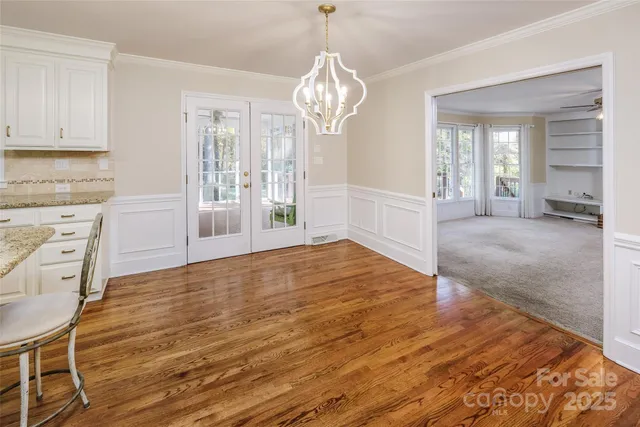 a view of a kitchen with wooden floor and chandelier