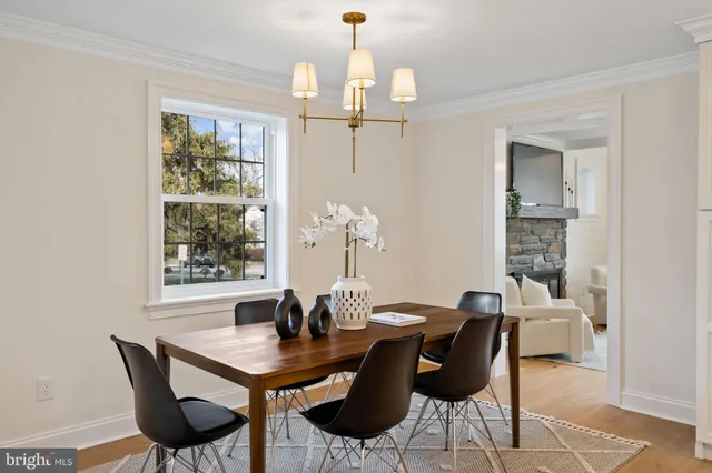 a bathroom with a toilet a sink a mirror and a window