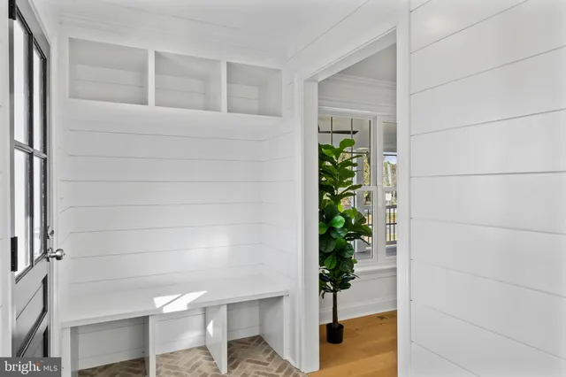 a living room with furniture a rug and a flat screen tv