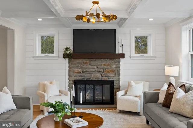 a living room with furniture a dining table and a painting on the wall