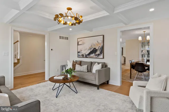 a kitchen island with stainless steel appliances kitchen island granite countertop a table chairs and a wooden floor