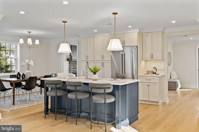 a bathroom with a granite countertop sink vanity mirror and toilet