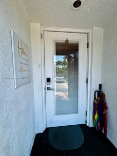 a room with wooden floor and a carpet