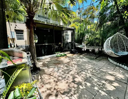 a backyard of a house with yard and outdoor seating