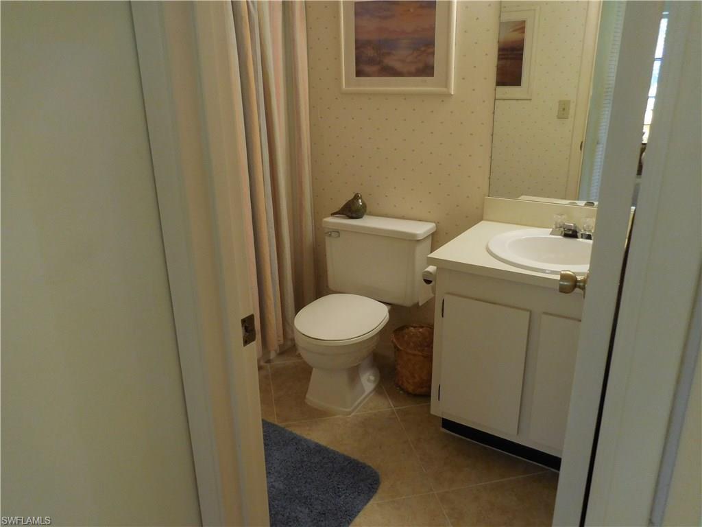 4287 27th Court Southwest, Unit 202 Naples, FL 34116 - Photo 13 of 22 a bathroom with a sink and a toilet