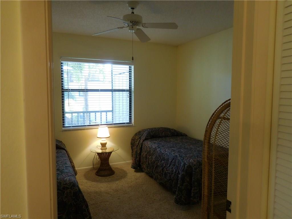 4287 27th Court Southwest, Unit 202 Naples, FL 34116 - Photo 14 of 22 a bedroom with a bed and window
