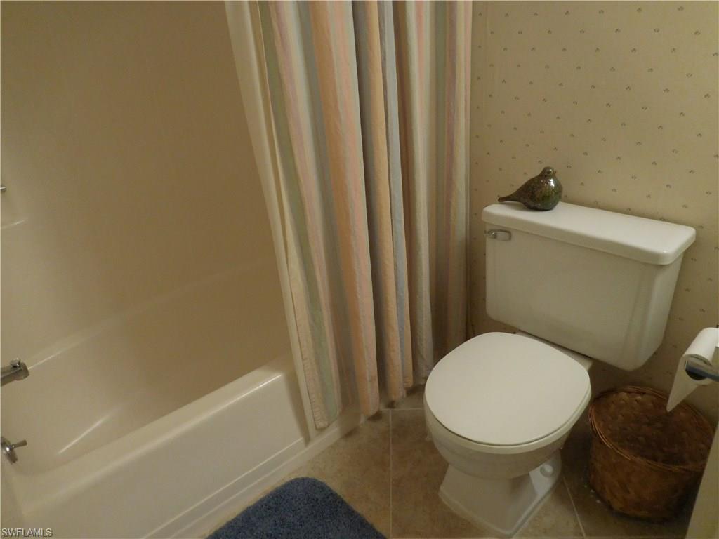 4287 27th Court Southwest, Unit 202 Naples, FL 34116 - Photo 16 of 22 a white toilet sitting next to a sink