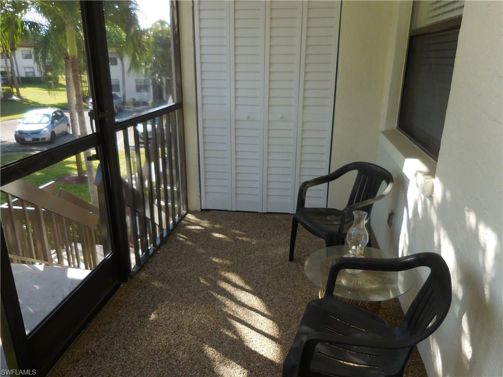 4287 27th Court Southwest, Unit 202 Naples, FL 34116 - Photo 20 of 22 a view of a porch with furniture and yard