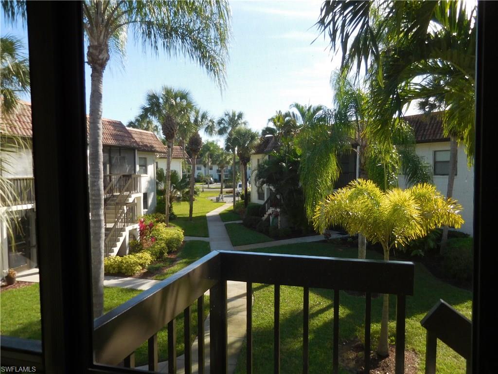 4287 27th Court Southwest, Unit 202 Naples, FL 34116 - Photo 4 of 22 a view of a balcony with a tree