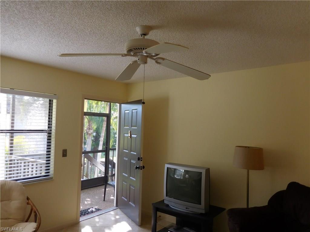 4287 27th Court Southwest, Unit 202 Naples, FL 34116 - Photo 8 of 22 a view of a workspace with furniture and a window