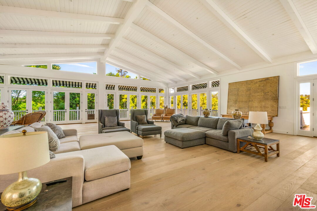 9669 Oak Pass Road Beverly Hills, CA 90210 - Photo 18 of 37 a living room with furniture and a large window