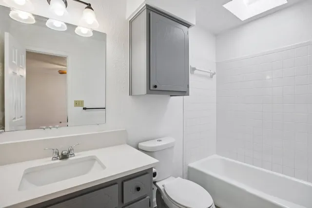 a bathroom with a sink a toilet and bathtub