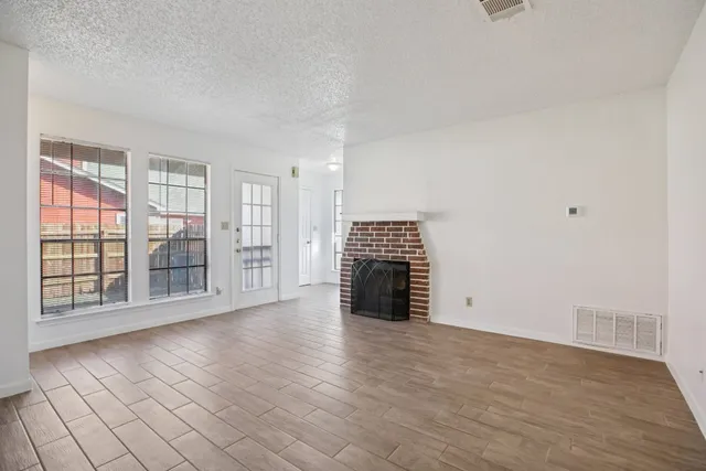 wooden floor in an empty room with a fireplace