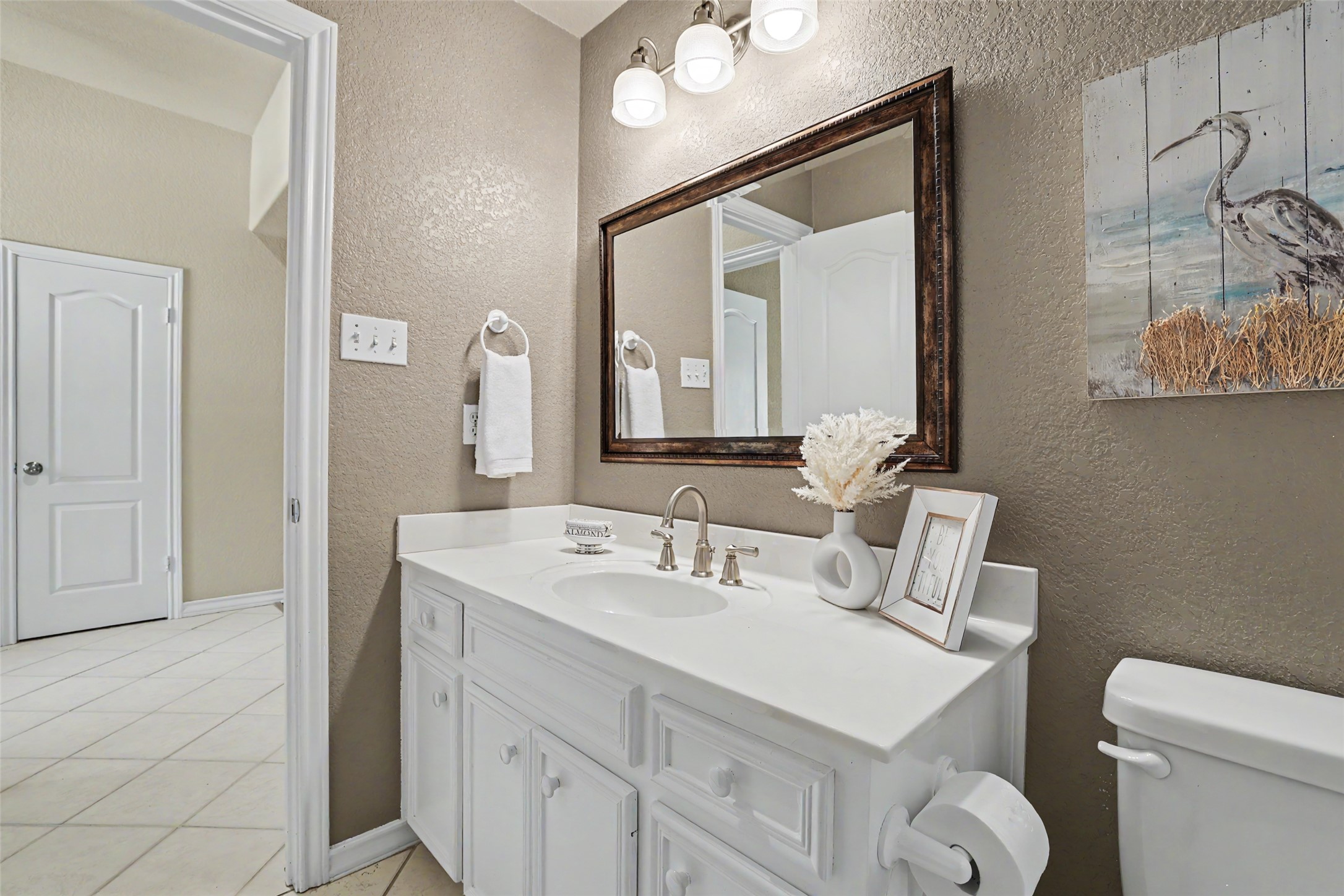 30107 Hamlet Circle Georgetown, TX 78628 - Photo 24 of 40 White vanity with a spacious countertop offers a crisp, clean aesthetic in this well-appointed bathroom.