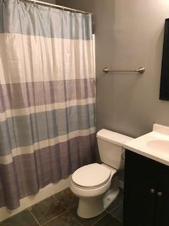 2425 25th Street Lubbock, TX 79411 - Photo 11 of 13 a white toilet sitting next to a shower curtain