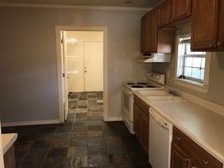 2425 25th Street Lubbock, TX 79411 - Photo 4 of 13 a utility room with cabinets washer and dryer