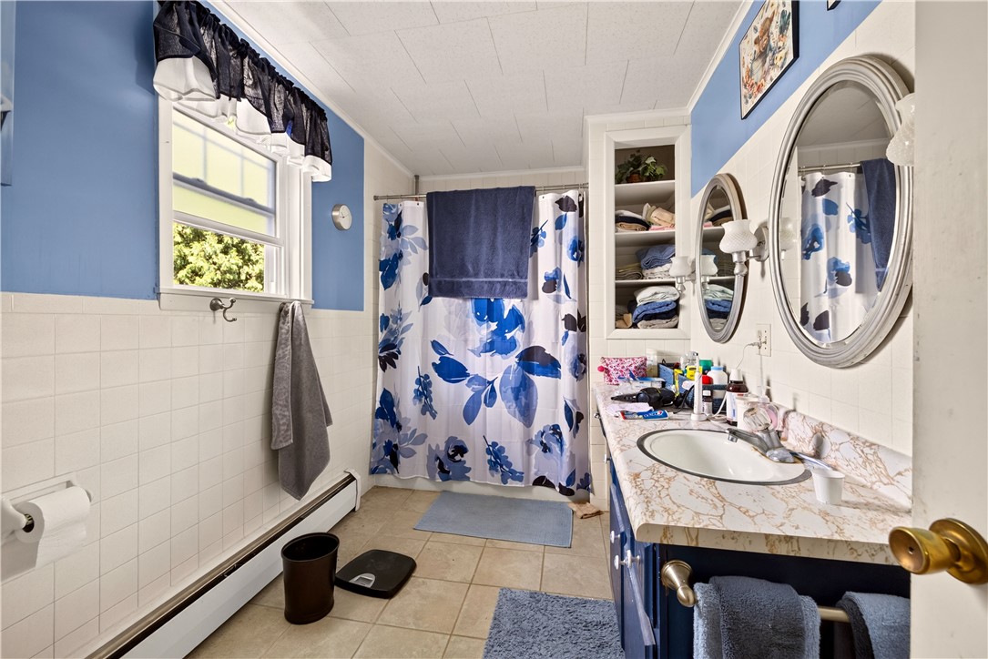 7780 Cold Springs Road Bath, NY 14810 - Photo 20 of 50 Tile flooring and classic wall paneling define this bathroom featuring built-in shelving.