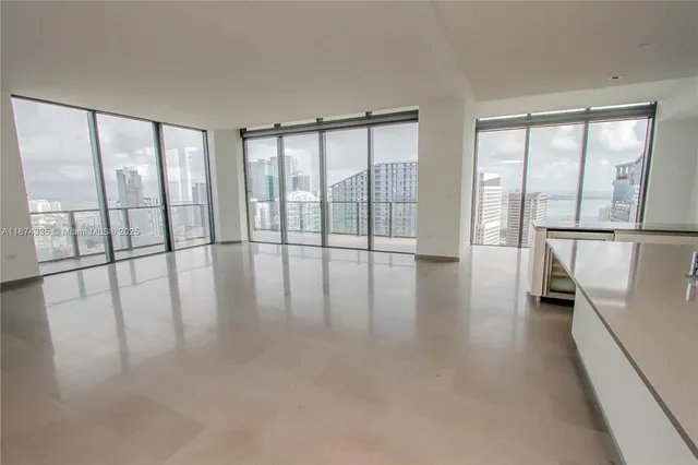 en empty room with sliding door and windows