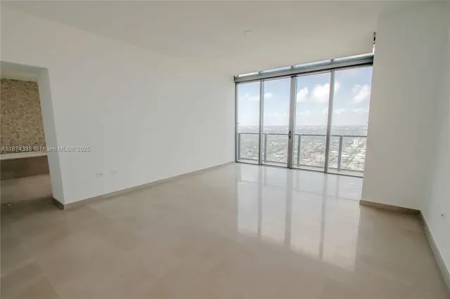 a view of an empty room with glass door