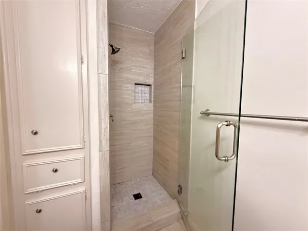 a bathroom with a glass shower door