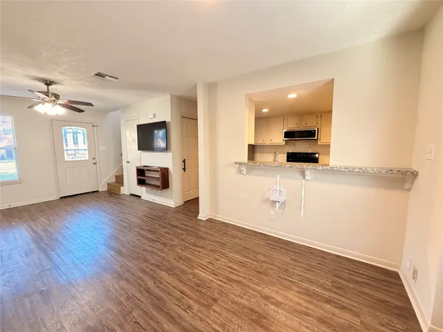 a view of a kitchen with a sink and a refrigerator