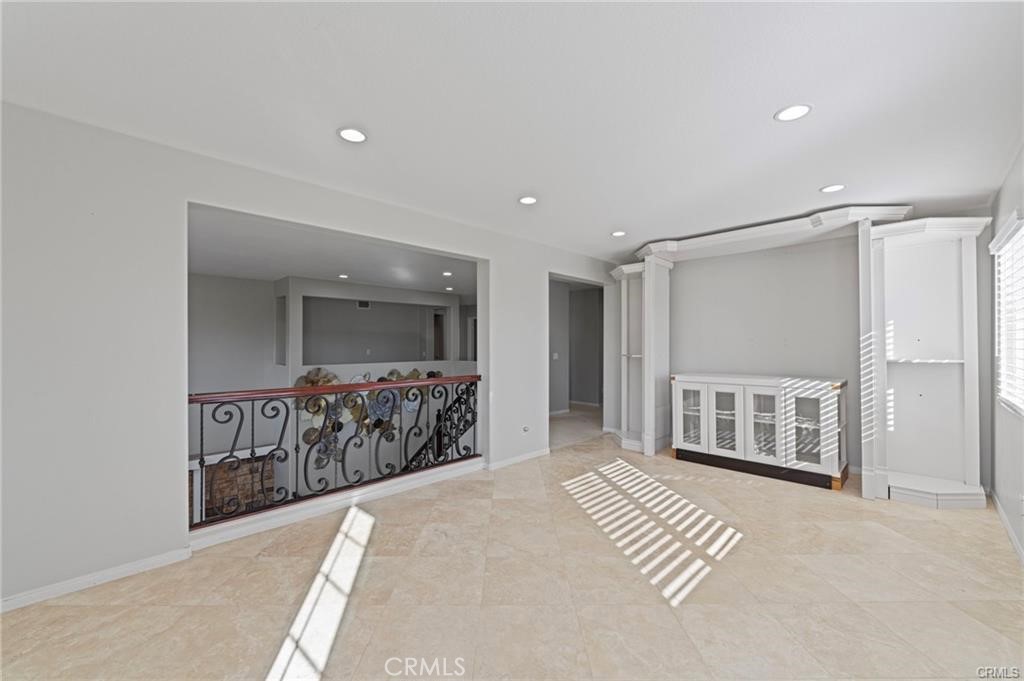 8634 Hunt Canyon Road Corona, CA 92883 - Photo 16 of 31 a spacious bedroom with a large bed and chandelier