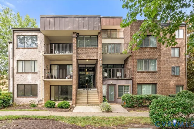 a front view of residential houses with yard