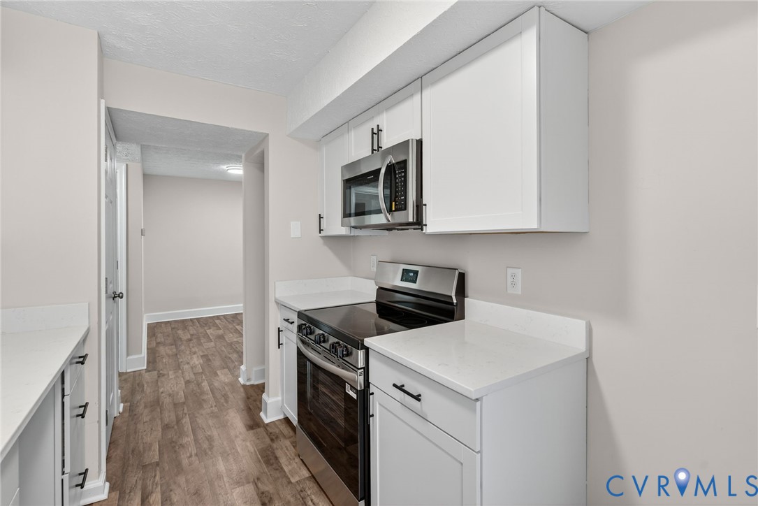 1501 Bronwyn Road, Unit 101 Henrico, VA 23238 - Photo 11 of 24 a kitchen with a stove and a microwave