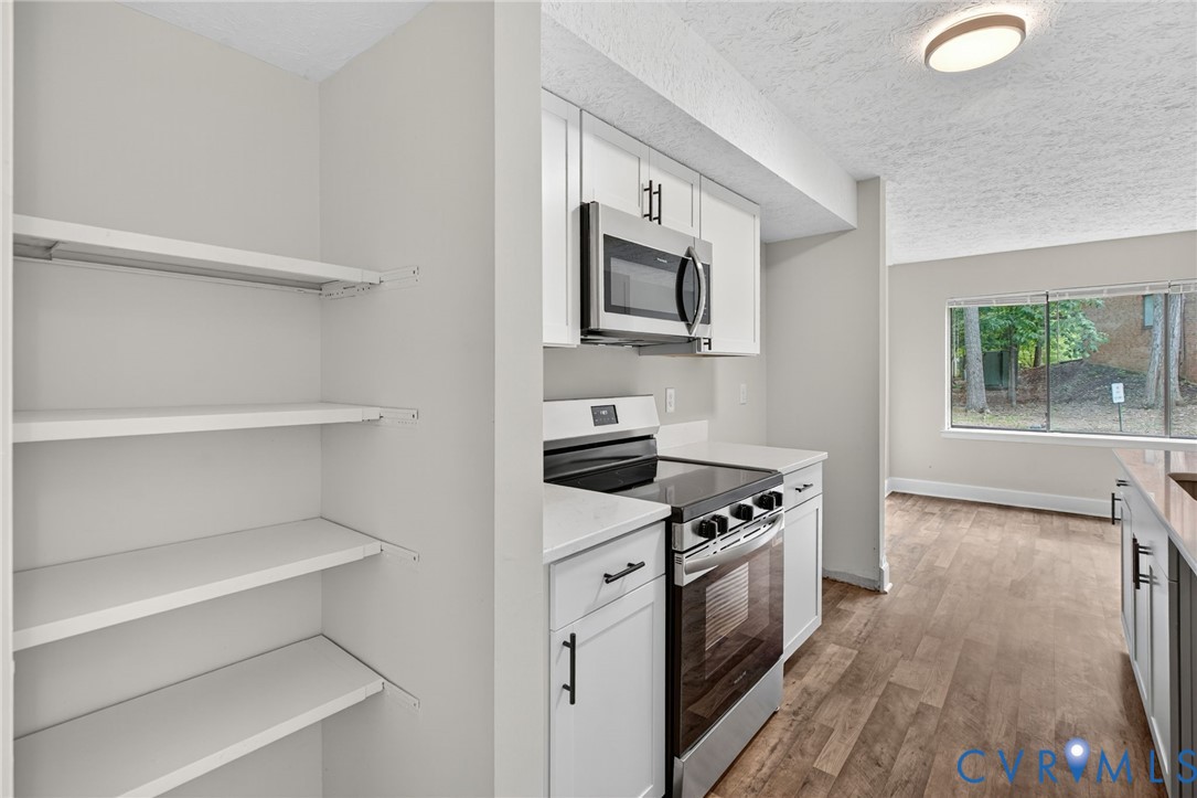 1501 Bronwyn Road, Unit 101 Henrico, VA 23238 - Photo 13 of 24 a kitchen with white cabinets and appliances