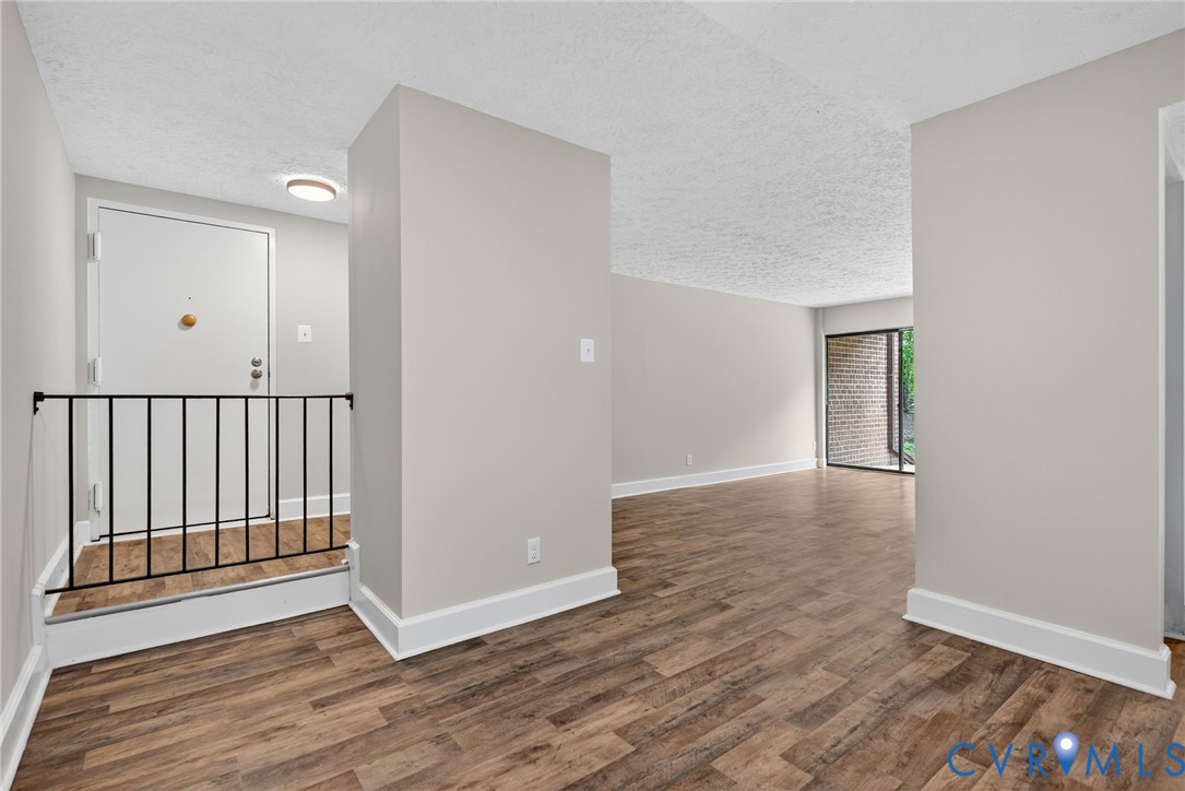 1501 Bronwyn Road, Unit 101 Henrico, VA 23238 - Photo 14 of 24 an empty room with wooden floor and windows