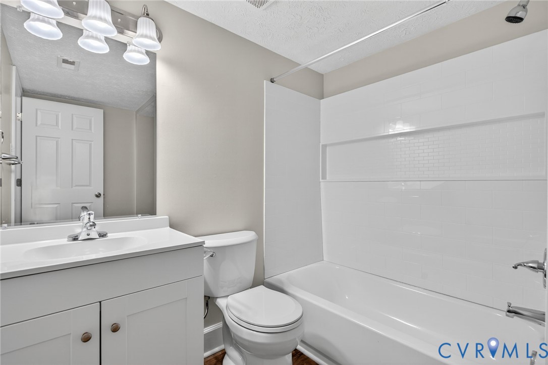 1501 Bronwyn Road, Unit 101 Henrico, VA 23238 - Photo 20 of 24 a bathroom with a sink a toilet and a bathtub