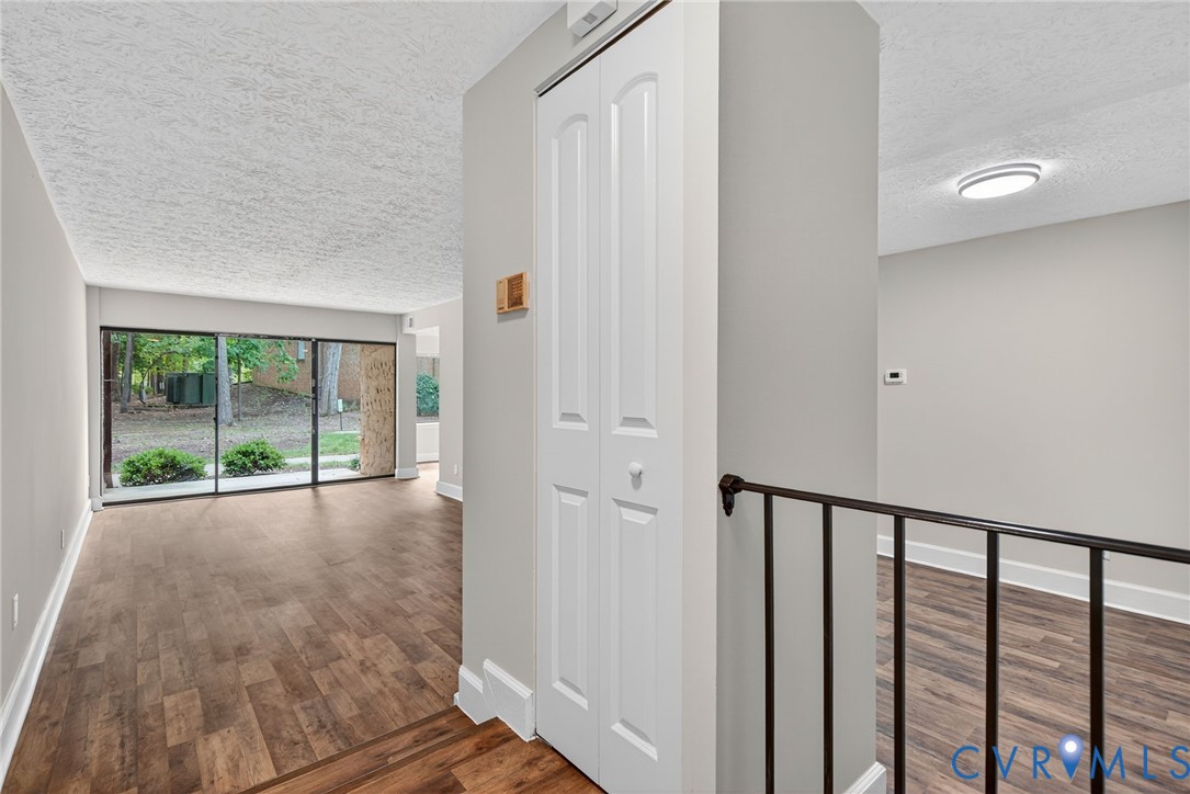 1501 Bronwyn Road, Unit 101 Henrico, VA 23238 - Photo 4 of 24 a view of empty room with wooden floor and fan