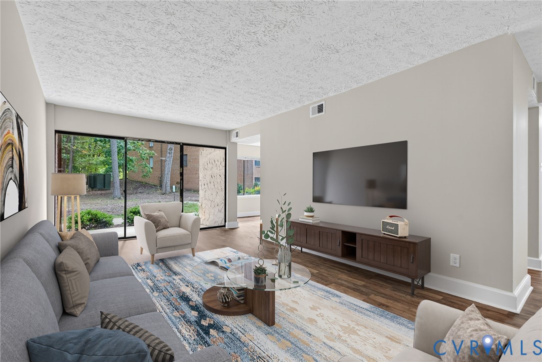 1501 Bronwyn Road, Unit 101 Henrico, VA 23238 - Photo 5 of 24 a living room with furniture and a flat screen tv