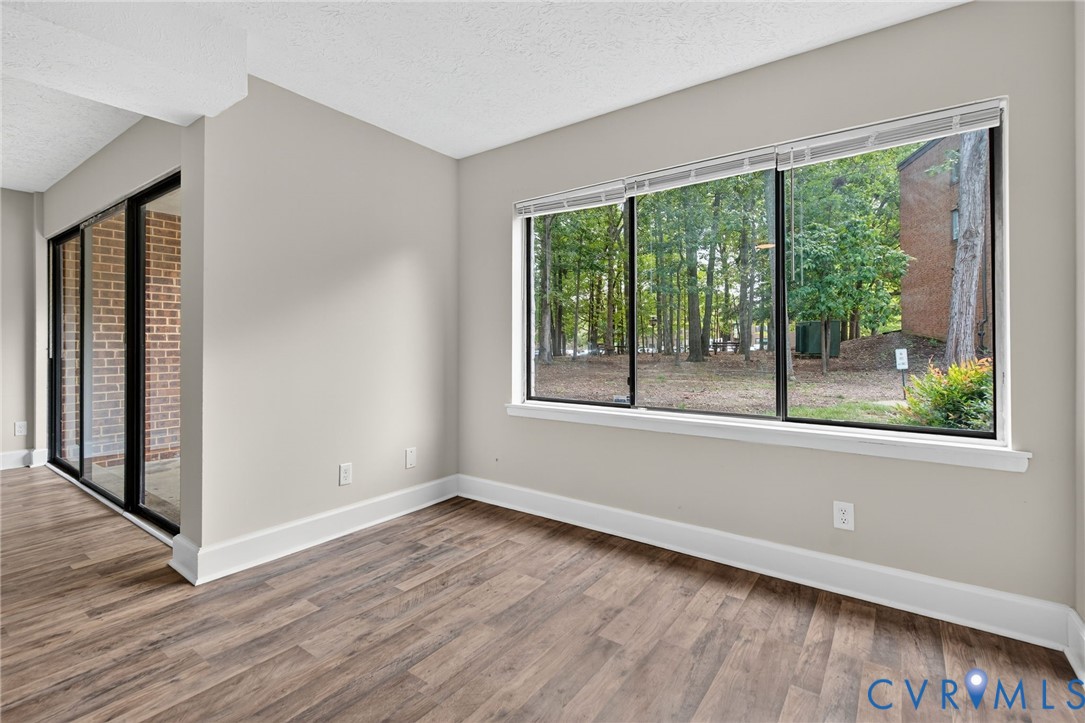1501 Bronwyn Road, Unit 101 Henrico, VA 23238 - Photo 8 of 24 a view of an empty room with wooden floor and a window