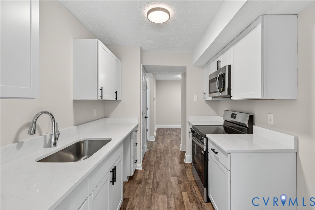 1501 Bronwyn Road, Unit 101 Henrico, VA 23238 - Photo 10 of 24 a kitchen with a sink a stove and cabinets