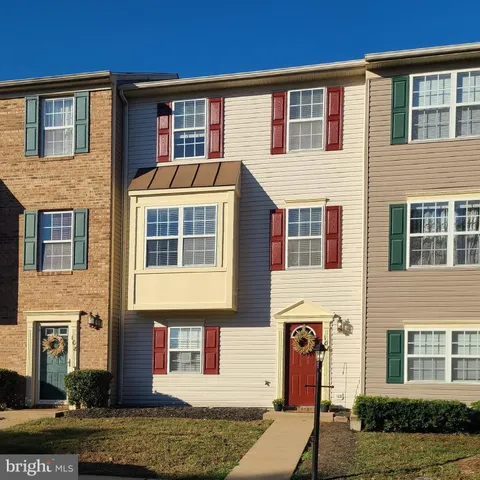 a front view of a residential apartment building with a yard
